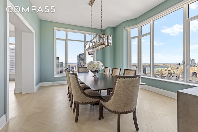 30 Park Pl Unit 64A, New York City, NY 10007 - dining space featuring a chandelier, a city view, and plenty of natural light