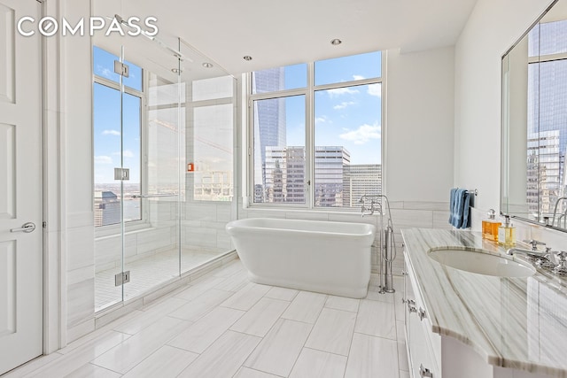 30 Park Pl Unit 64A, New York City, NY 10007 - bathroom featuring a freestanding bath, vanity, and a shower stall