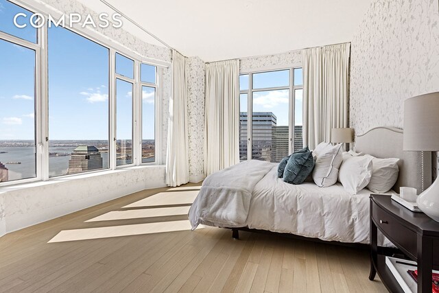 30 Park Pl Unit 64A, New York City, NY 10007 - bedroom with wallpapered walls and wood finished floors