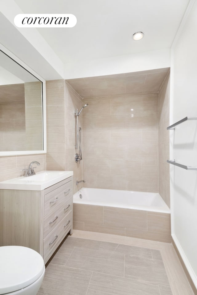 425 Convent Ave, New York City, NY 10031 - bathroom featuring tiled shower / bath combo, vanity, tile patterned floors, toilet, and tile walls