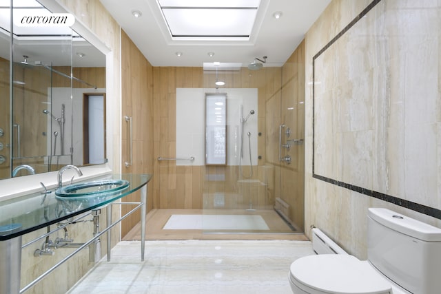 425 Convent Ave, New York City, NY 10031 - bathroom featuring a sink, toilet, baseboard heating, a stall shower, and tile walls
