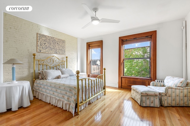 425 Convent Ave, New York City, NY 10031 - bedroom with light wood-type flooring, brick wall, and a ceiling fan