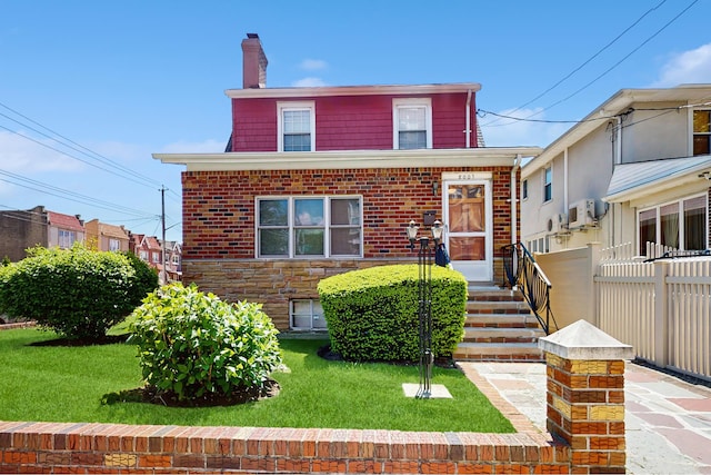 view of front facade with a chimney and brick siding