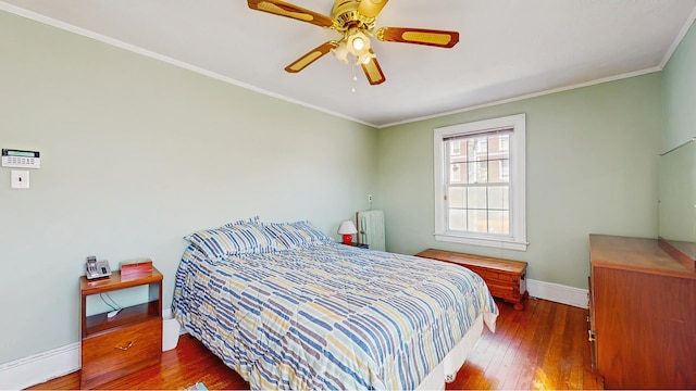bedroom with baseboards, radiator, hardwood / wood-style flooring, ornamental molding, and ceiling fan