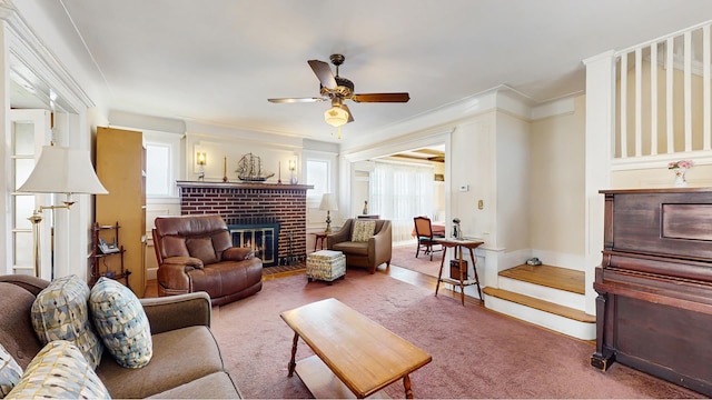 carpeted living area featuring plenty of natural light, a ceiling fan, a fireplace, and baseboards