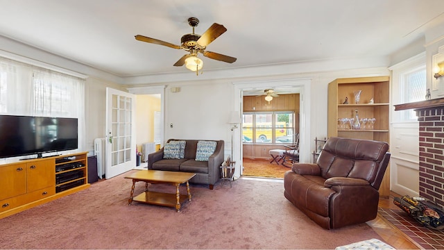 carpeted living area featuring a ceiling fan and radiator heating unit