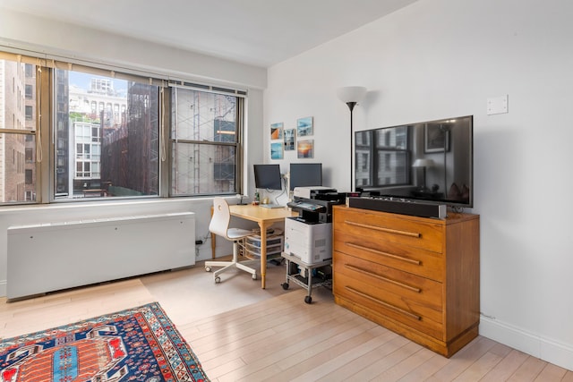 10 W 15th St Unit 927, New York City, NY 10011 - home office featuring radiator and wood finished floors