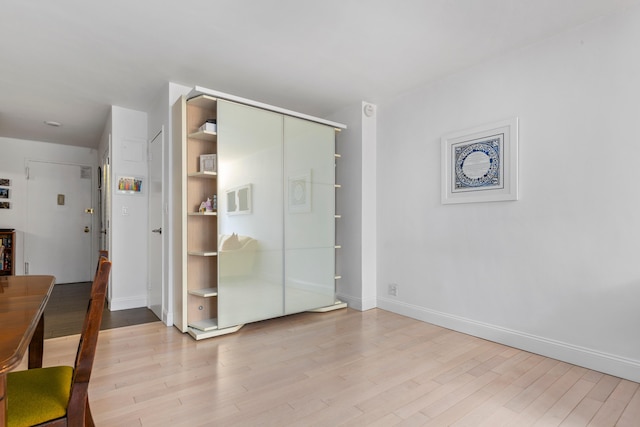 10 W 15th St Unit 927, New York City, NY 10011 - unfurnished bedroom with wood finished floors and a closet