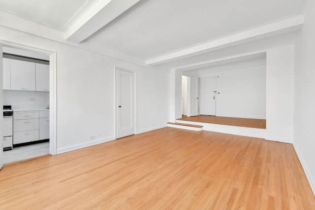 10 Park Ave Unit 9-E, New York City, NY 10016 - empty room featuring beamed ceiling, light wood-type flooring, and baseboards