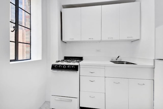 10 Park Ave Unit 9-E, New York City, NY 10016 - kitchen featuring gas range gas stove, a sink, light countertops, and white cabinetry