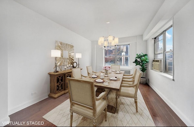 dining space with a chandelier, wood finished floors, baseboards, and cooling unit