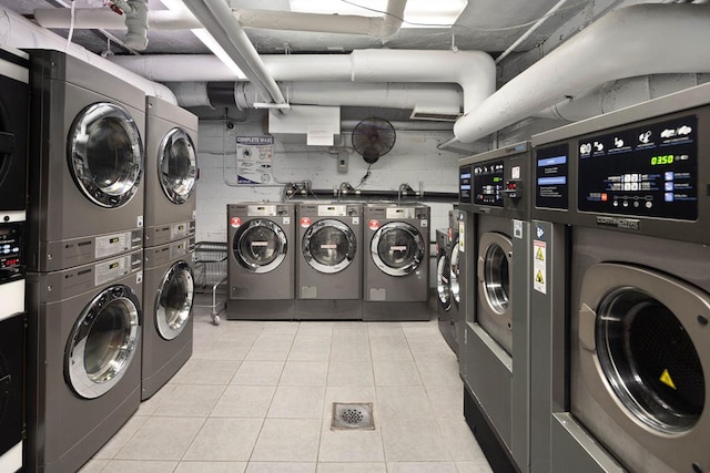 233 E 69th St Unit 17-G, New York City, NY 10021 - communal laundry room featuring stacked washer and clothes dryer, separate washer and dryer, and light tile patterned flooring