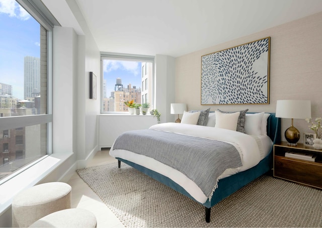bedroom with a view of skyline and baseboards