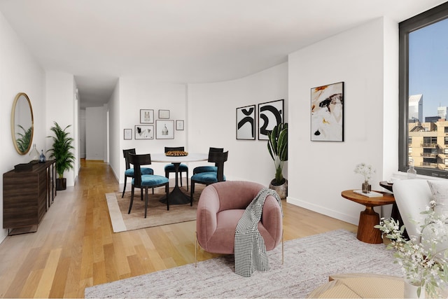 dining room with light wood-style floors and baseboards