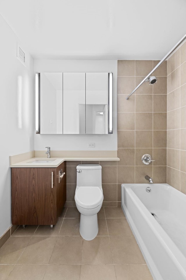 bathroom featuring tile patterned flooring, washtub / shower combination, vanity, and toilet