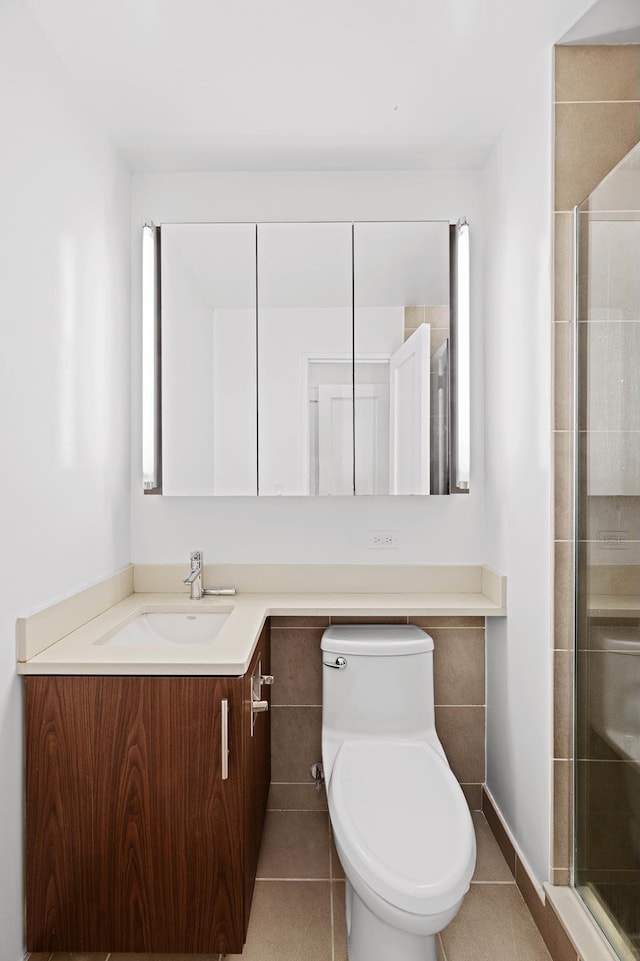 full bathroom with tile patterned floors, a stall shower, vanity, and toilet
