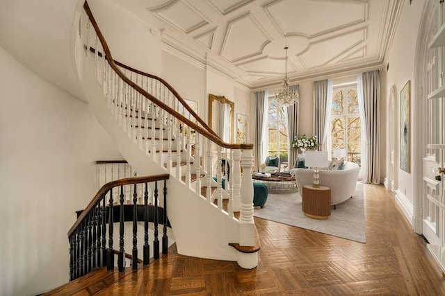 243 E 17th St, New York City, NY 10003 - staircase featuring a chandelier, crown molding, baseboards, and coffered ceiling