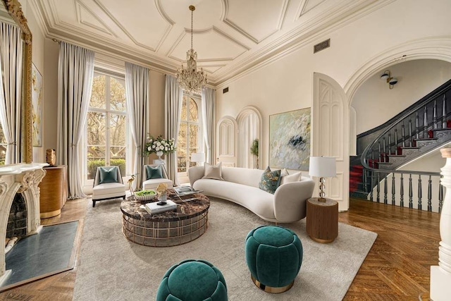 243 E 17th St, New York City, NY 10003 - living area featuring a chandelier, stairs, ornamental molding, and a towering ceiling