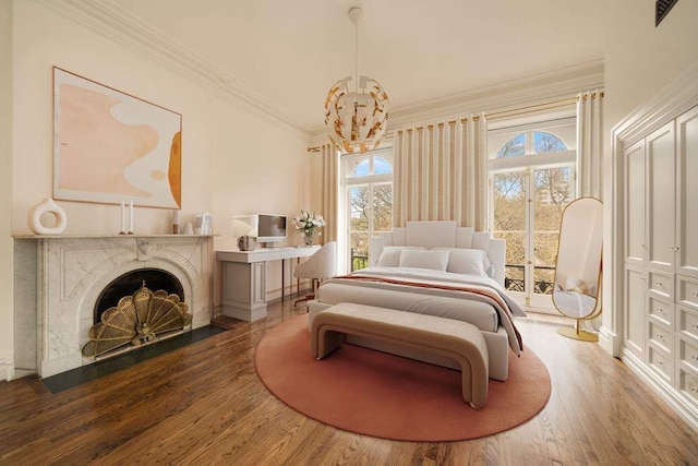 243 E 17th St, New York City, NY 10003 - bedroom featuring ornamental molding, wood finished floors, access to exterior, a chandelier, and a premium fireplace
