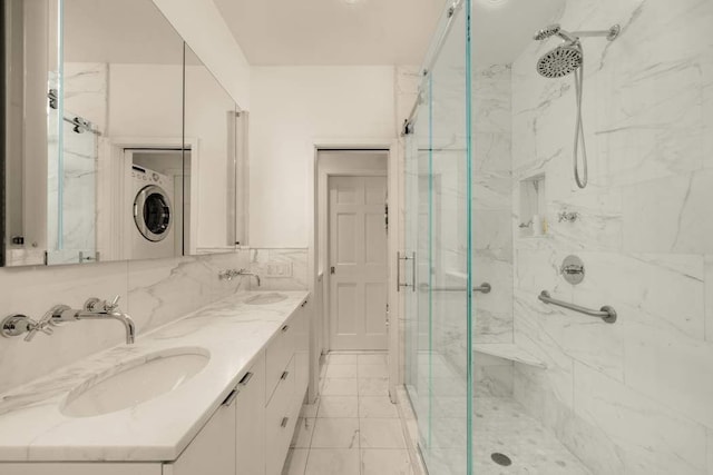 243 E 17th St, New York City, NY 10003 - full bathroom featuring a marble finish shower, estacked washer and dryer, and double vanity