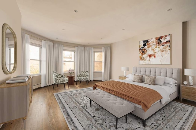 243 E 17th St, New York City, NY 10003 - bedroom with wood finished floors, multiple windows, and a baseboard radiator