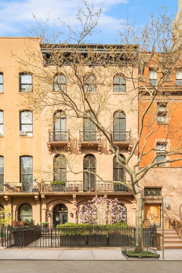 243 E 17th St, New York City, NY 10003 - view of apartment building / complex featuring a fenced front yard