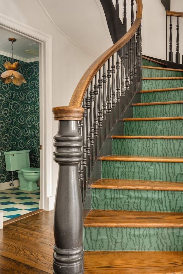 243 E 17th St, New York City, NY 10003 - stairs with wallpapered walls, wood finished floors, and crown molding