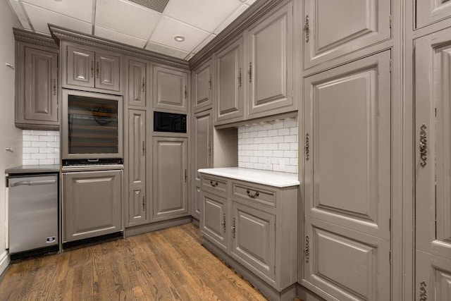 243 E 17th St, New York City, NY 10003 - kitchen with beverage cooler, tasteful backsplash, wood finished floors, and light countertops