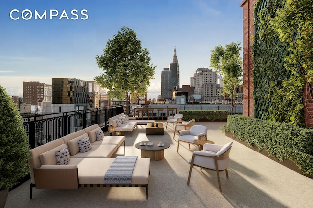 view of patio / terrace with an outdoor living space, a view of skyline, and fence