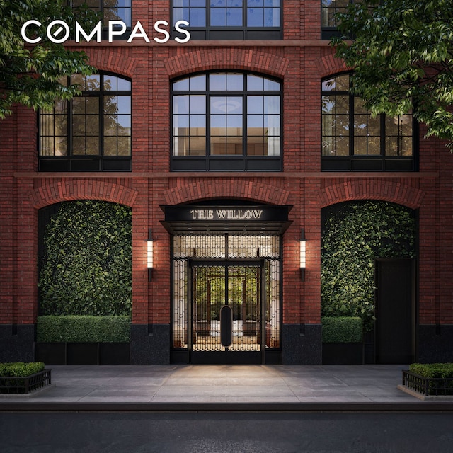 201 E 23rd St Unit 15C, New York City, NY 10010 - view of exterior entry featuring brick siding and a gate