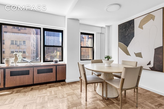 345 E 52nd St Unit 10Cd, New York City, NY 10022 - dining area featuring baseboards