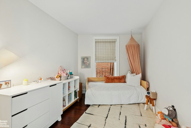 bedroom featuring dark wood finished floors