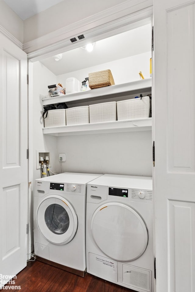 washroom with dark wood-style floors and washer and clothes dryer