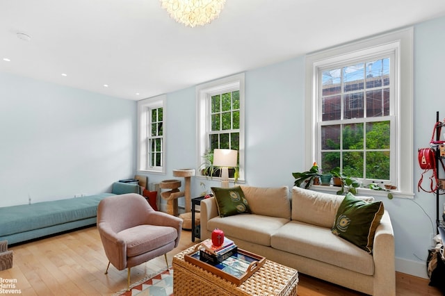 living area with light wood-type flooring, healthy amount of natural light, and recessed lighting