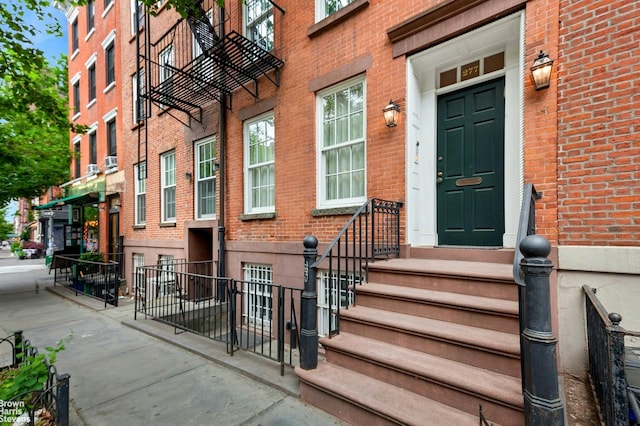 view of exterior entry with brick siding