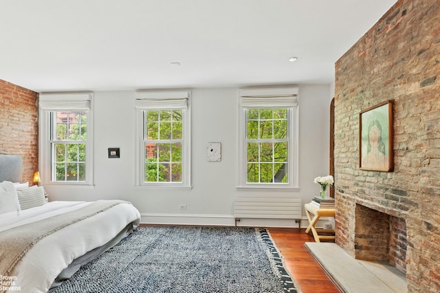 bedroom with wood finished floors and baseboards