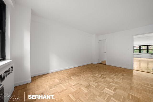301 E 63rd St Unit 3B, New York City, NY 10065 - spare room featuring baseboards and radiator heating unit