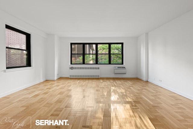 301 E 63rd St Unit 3B, New York City, NY 10065 - empty room featuring radiator, a wall unit AC, and baseboards