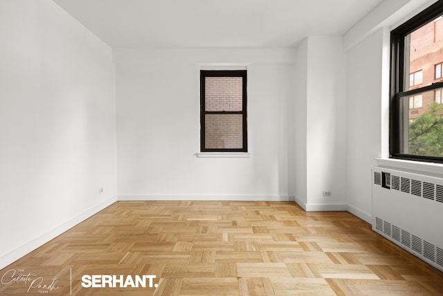 301 E 63rd St Unit 3B, New York City, NY 10065 - empty room with radiator heating unit and baseboards