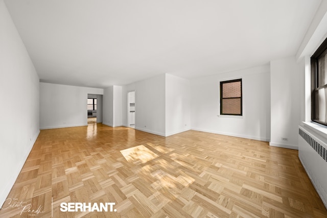 301 E 63rd St Unit 3B, New York City, NY 10065 - unfurnished living room with radiator and baseboards