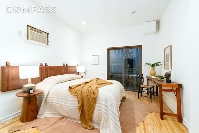 349 W 71st St, New York City, NY 10023 - bedroom with access to exterior, light wood-style floors, a wall mounted AC, recessed lighting, and baseboards