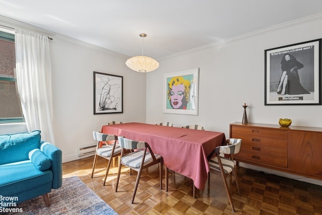 dining room featuring crown molding, a baseboard heating unit, and baseboards