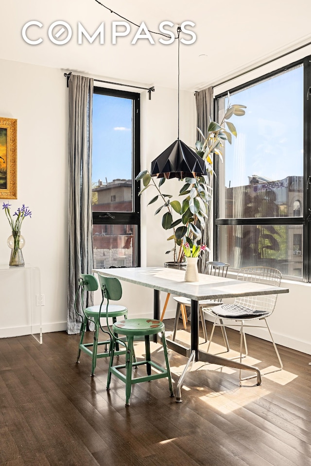 dining room with wood finished floors and baseboards