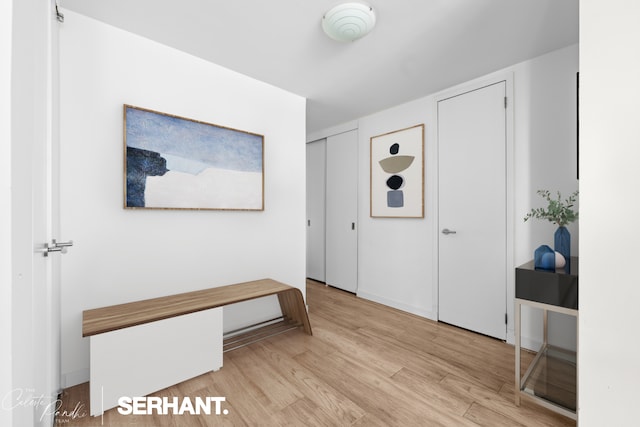 entryway featuring wood finished floors and baseboards