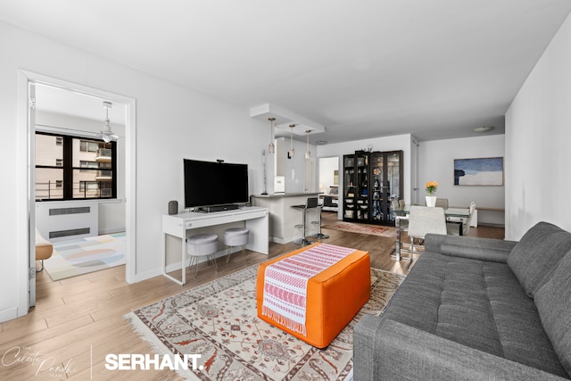 living area with wood finished floors and baseboards