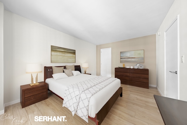 bedroom featuring wood finished floors and baseboards