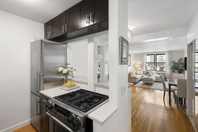 330 E 70th St Unit 2-H, New York City, NY 10021 - kitchen featuring stainless steel appliances, light wood-style flooring, light countertops, and open floor plan