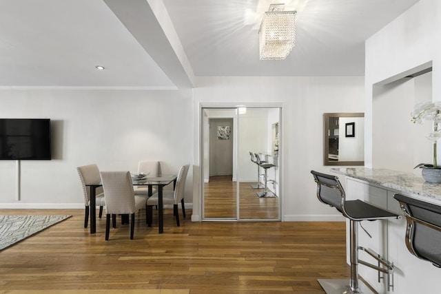 330 E 70th St Unit 2-H, New York City, NY 10021 - dining area with a chandelier, wood finished floors, and baseboards