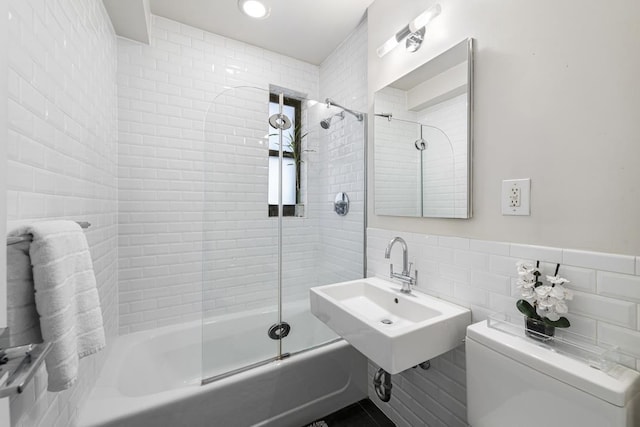 330 E 70th St Unit 2-H, New York City, NY 10021 - full bath with tile walls, shower / washtub combination, toilet, and a sink