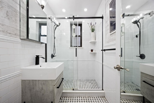 302 96th St Unit 4-R, New York City, NY 11209 - bathroom featuring vanity, tile walls, a shower stall, tile patterned floors, and recessed lighting